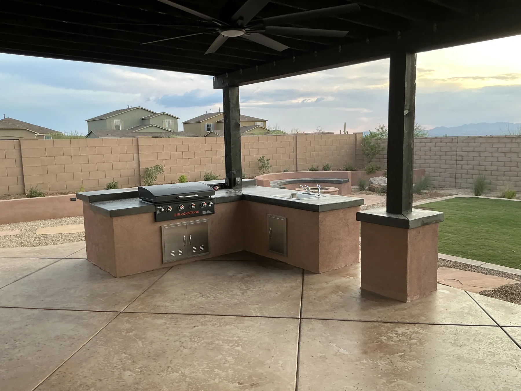 Covered outdoor patio with a built-in counter and seating area