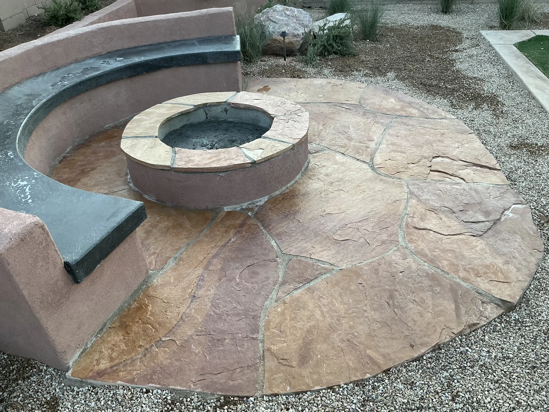Circular fire feature set into a paver courtyard